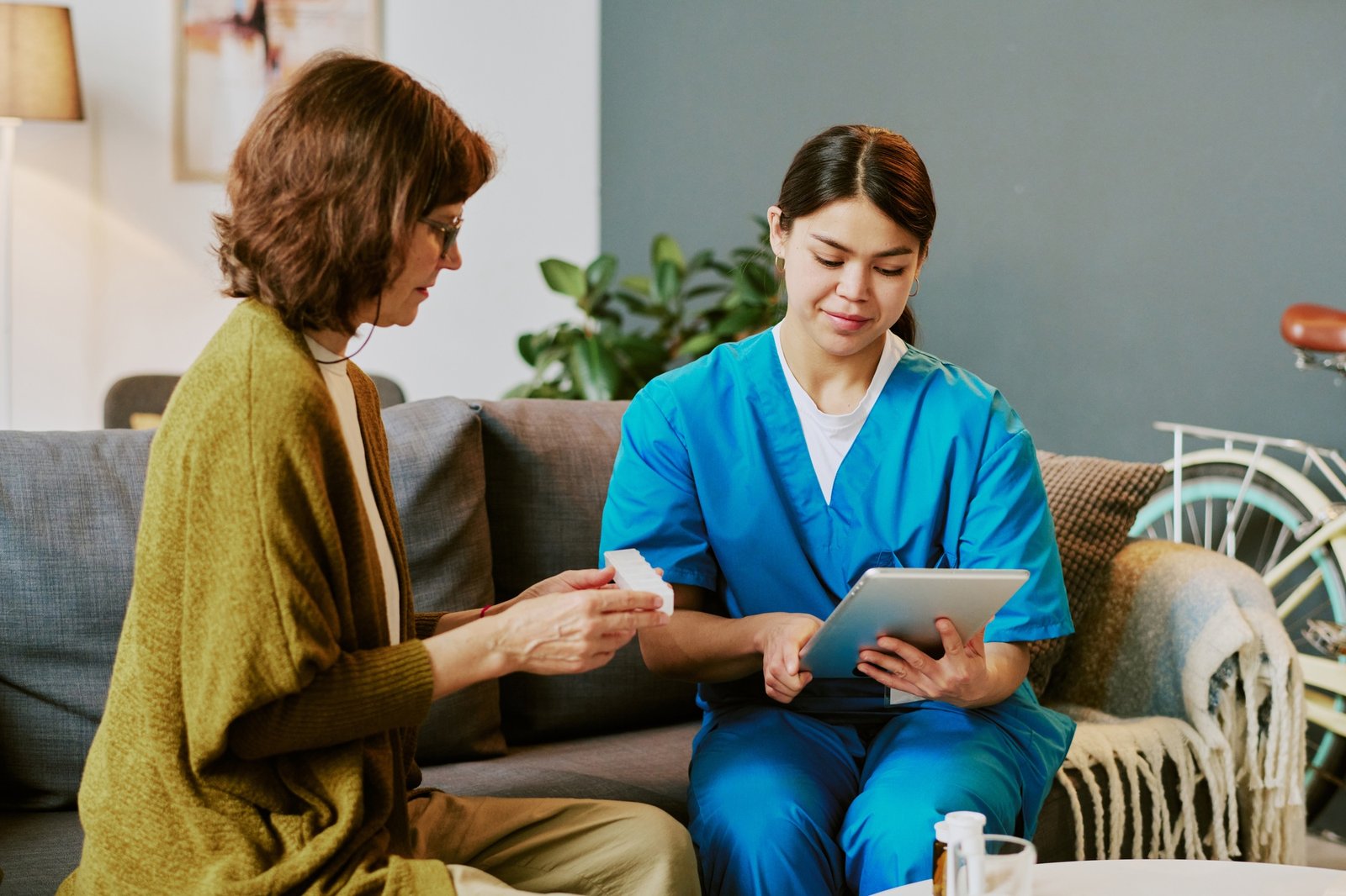 Caregiving Professional Assisting Elderly Patient at Home